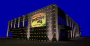 A brick building at night displays a large Greetings from Pottsville, Pennsylvania sign; yellow numerical notations cover the building’s facade.